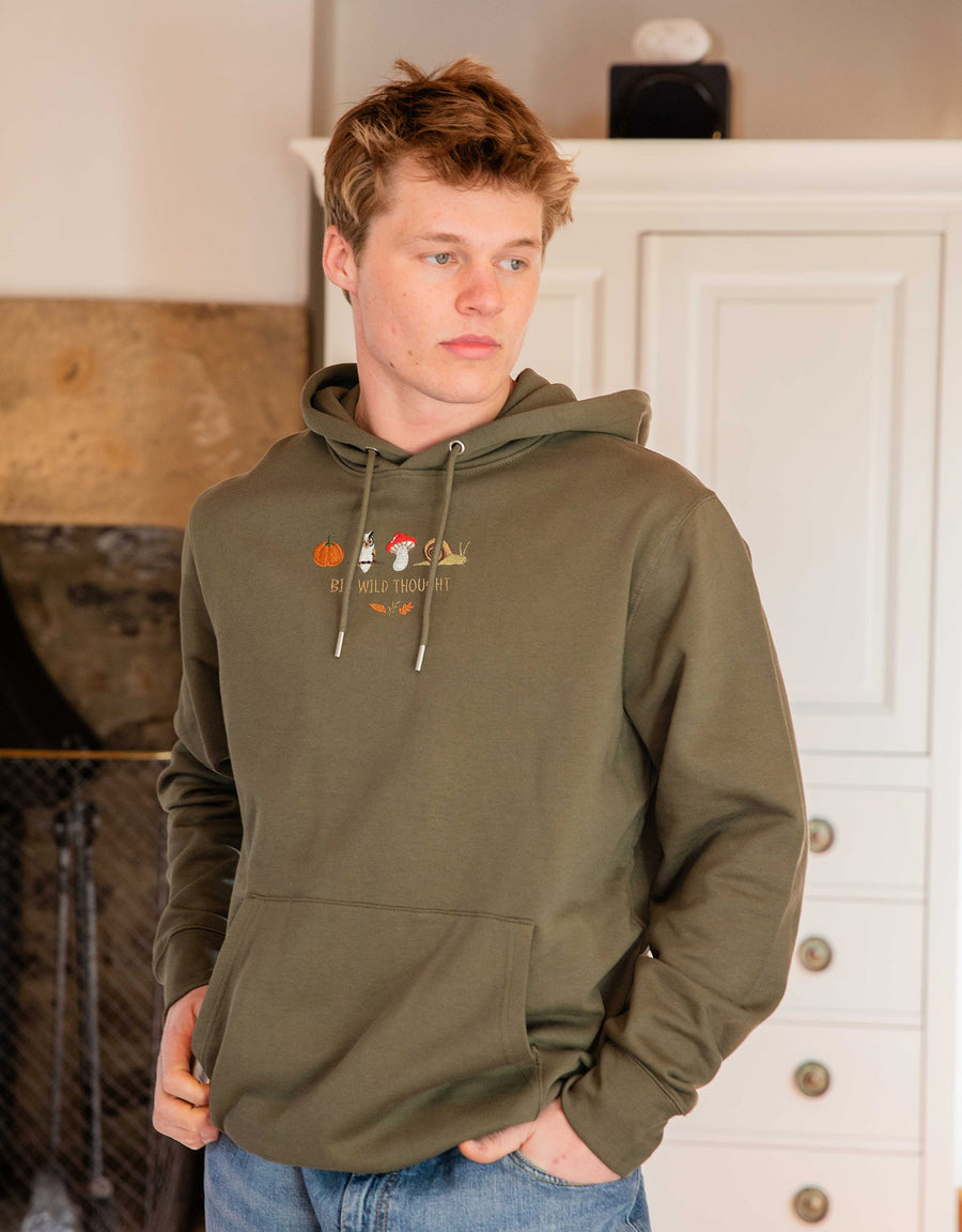 Cosy Autumn embroidered unisex hoodie in Khaki worn by a model, with a pumpkin, owl, toadstool and snail design