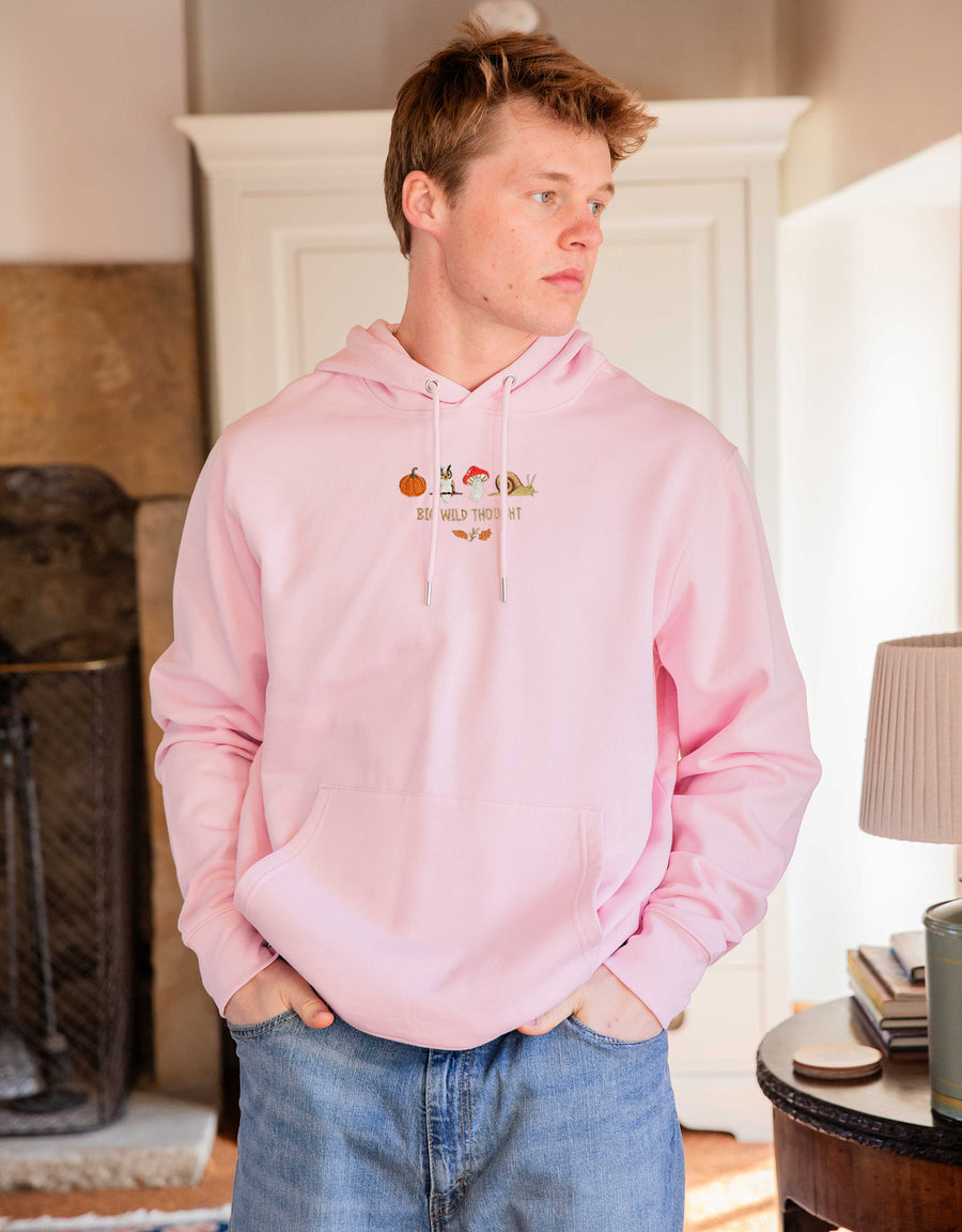 Cosy Autumn embroidered unisex hoodie in Pastel Pink worn by a model, with a pumpkin, owl, toadstool and snail design